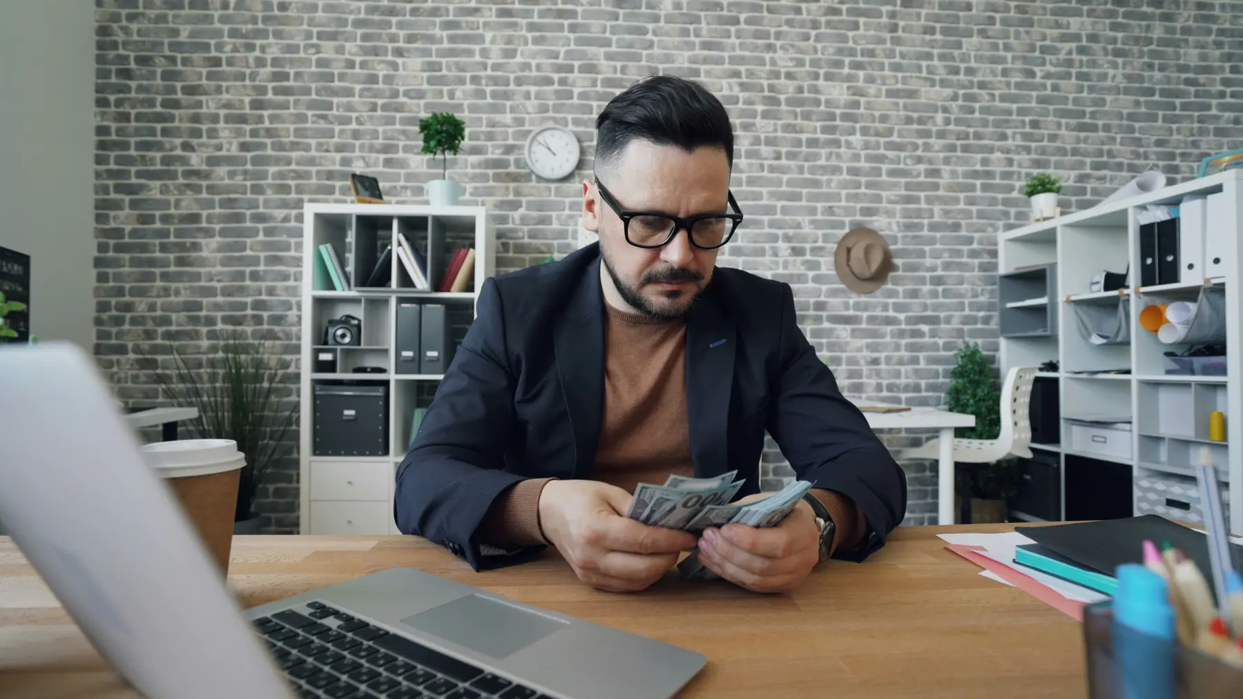 man at desk with money